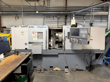 Front view of Okuma Genos L300E-M with FMB Turbo 8-80  machine